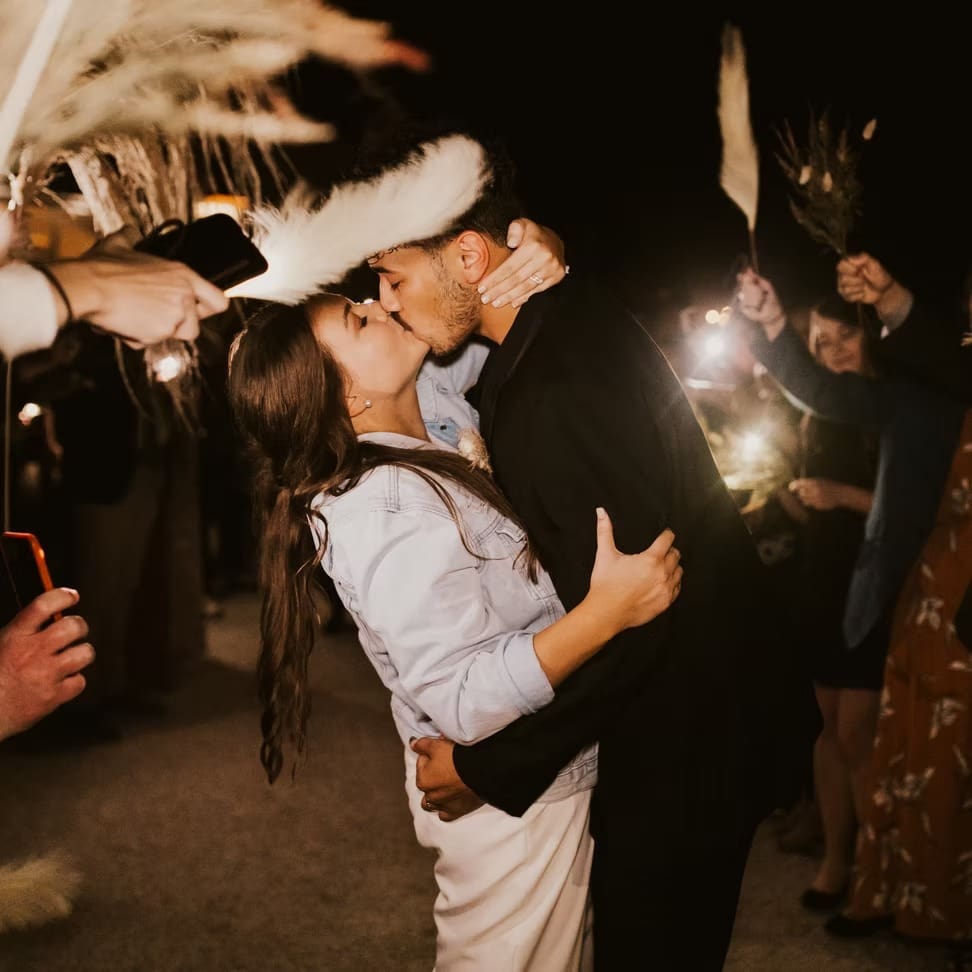 Bride and groom kiss wedding exit
