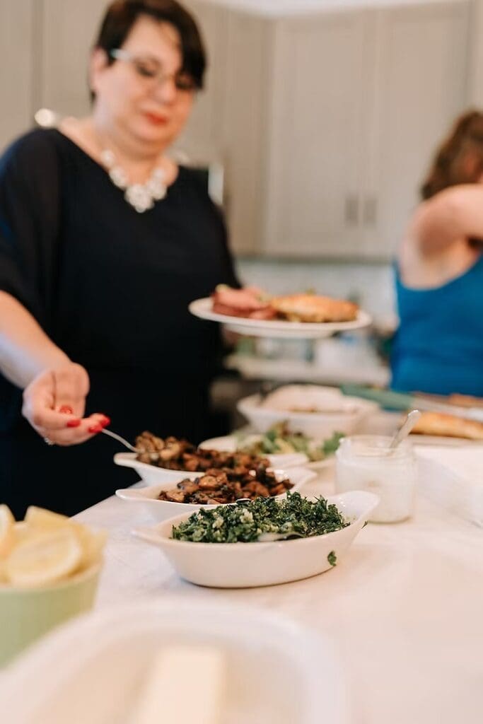 Woman putting food on plate