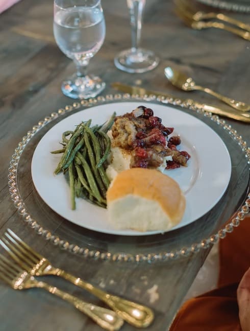 Wedding plate with green beans, meat, and roll